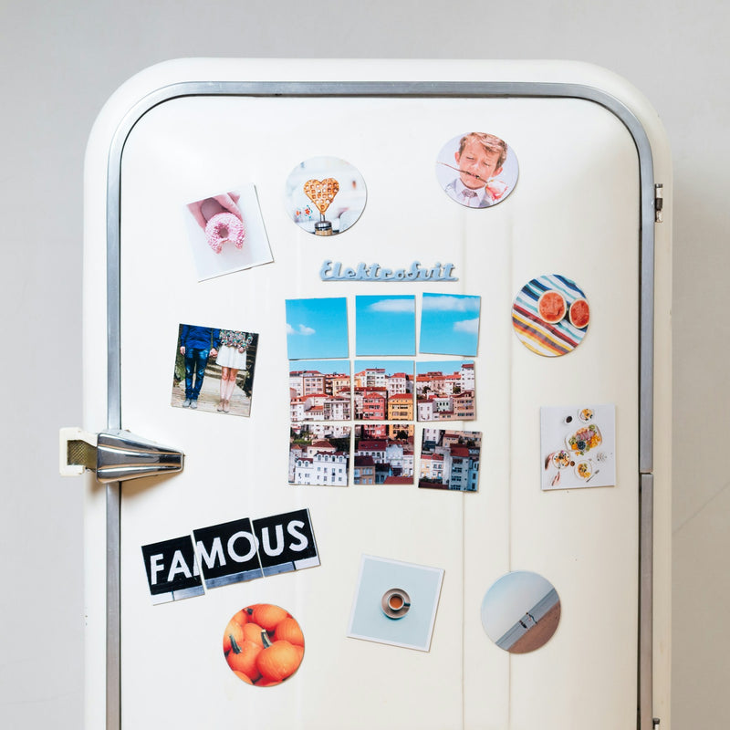 Family refrigerator covered with assorted photos and magnets